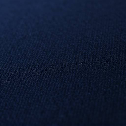 Close-up of a deep navy worsted wool fabric swatch with a subtle texture.
